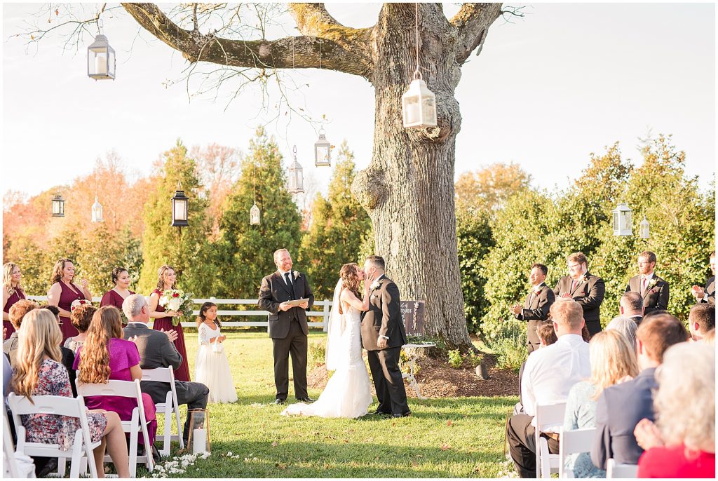 ceremony at amber grove virginia wedding venue bride and groom first kiss