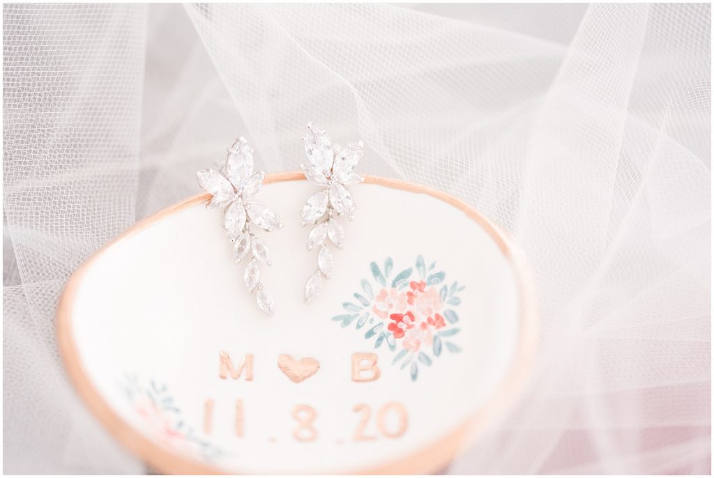 custom engraved ring dish wedding detail with dangly earrings