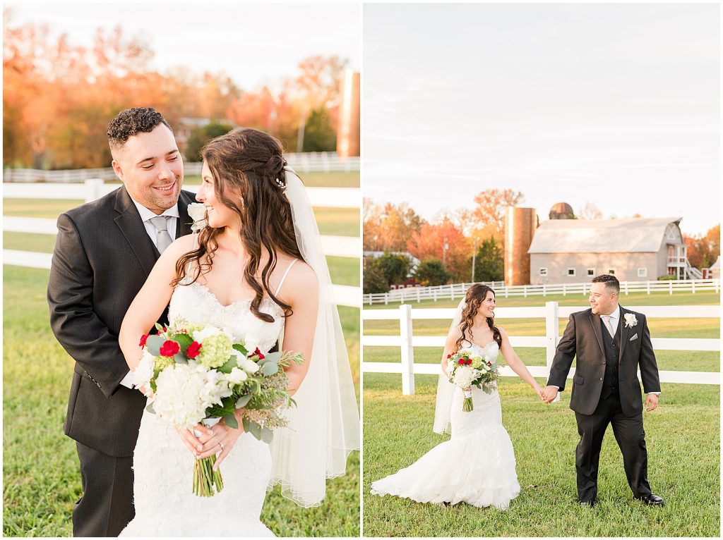 bride and groom standing in field with barn and fall trees behind them at amber grove richmond virginia