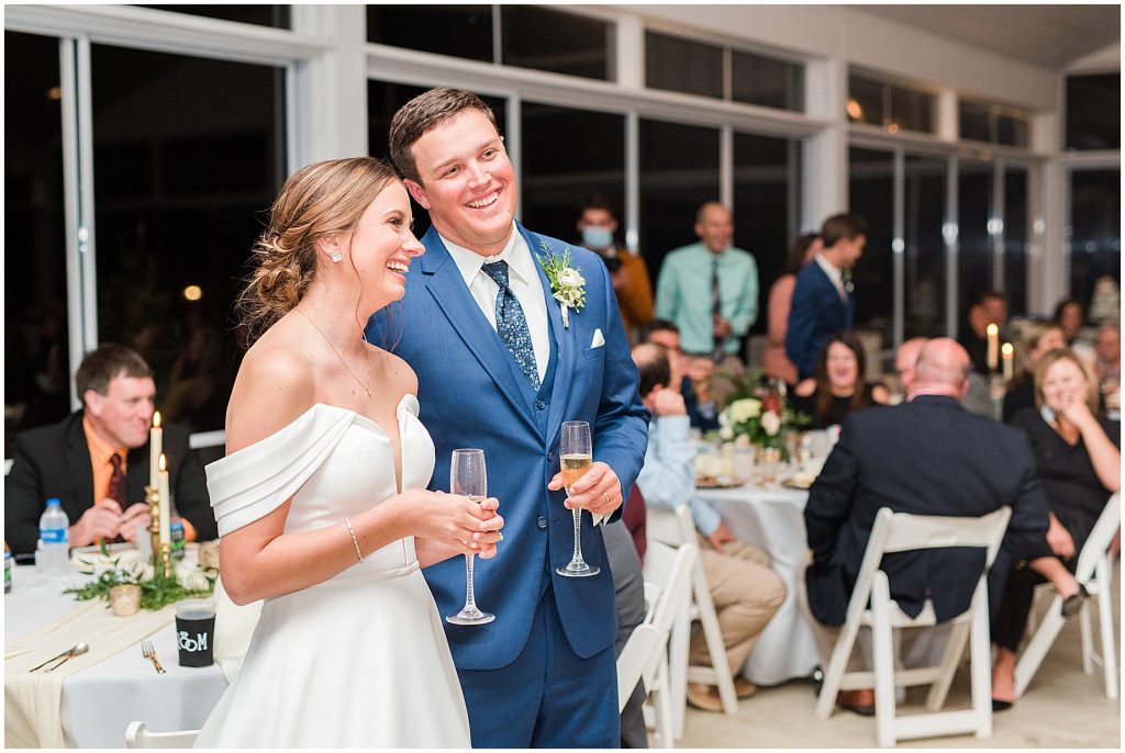 bride and groom laughing with champagne in hands at Waverly Estate reception