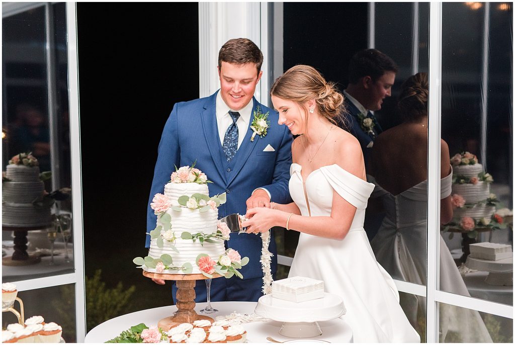 bride and groom cutting cake at Waverly Estate Reception