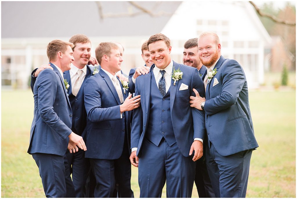 groomsmen hugging on groom outside at waverly estate in southern virginia