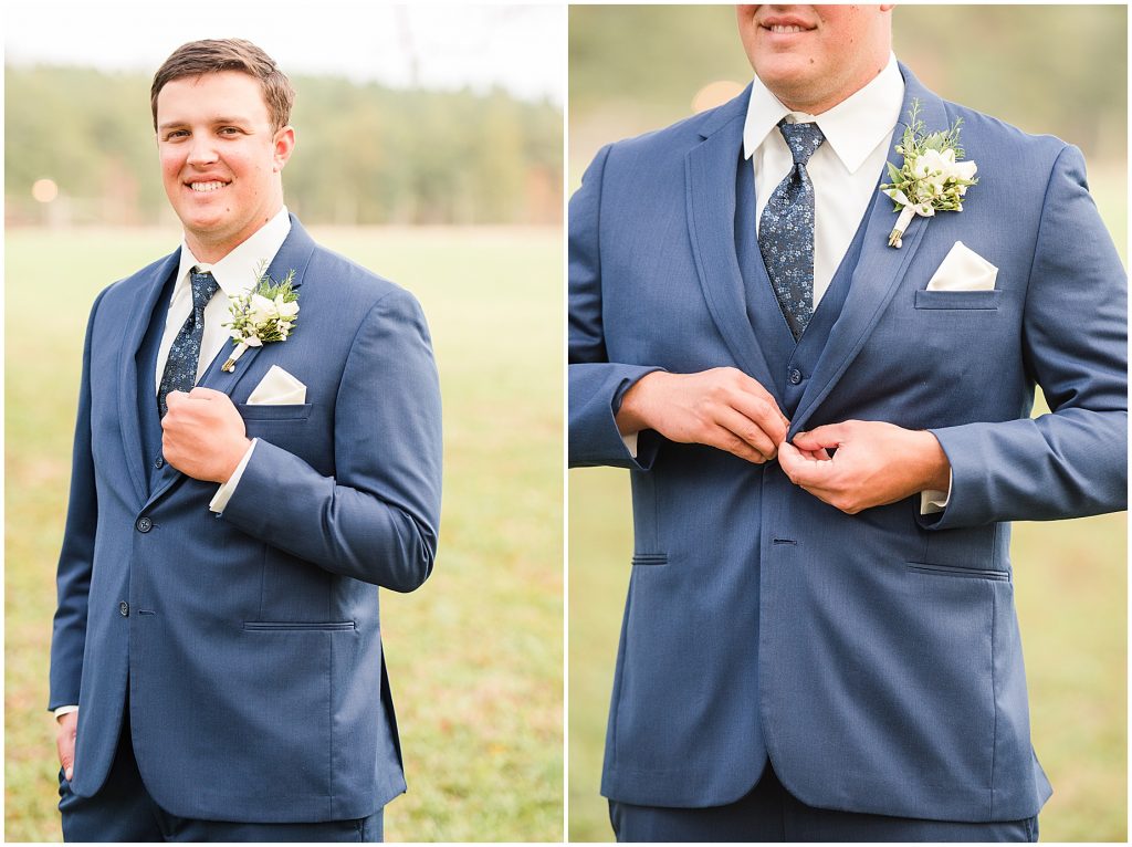 groom standing in blue suit and adjusting his cuff links at waverly estate in southern virginia