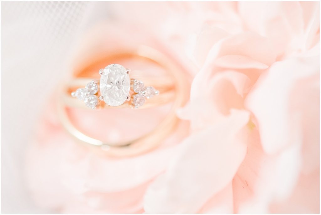 soft white and blush pink virginia wedding details of the rings on a flower