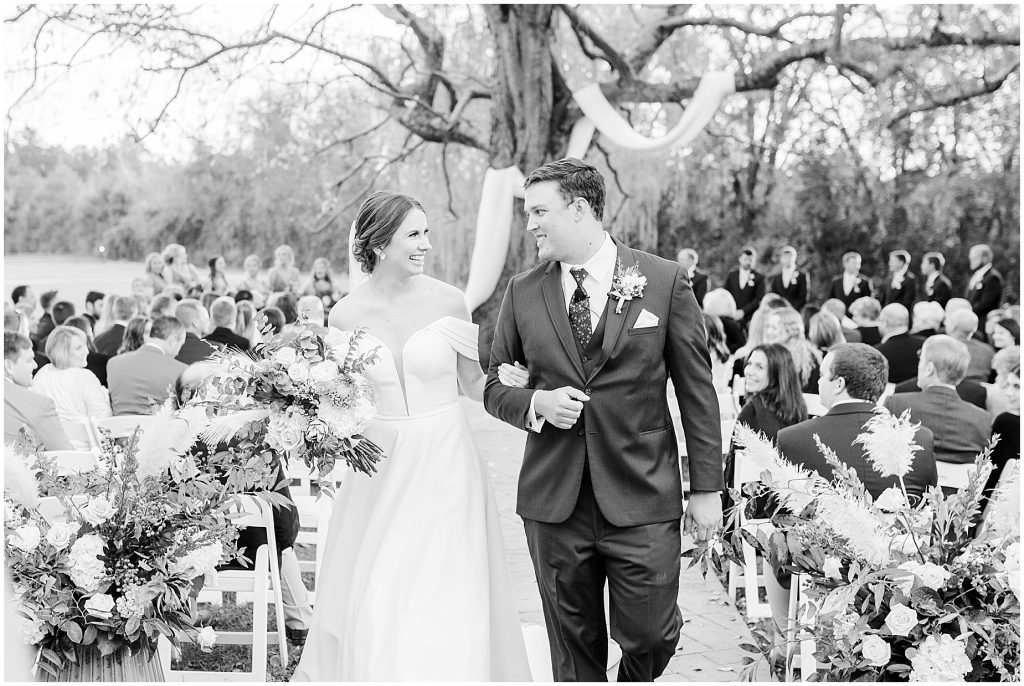 bride and groom walking down aisle married at Waverly Estate ceremony in black and white