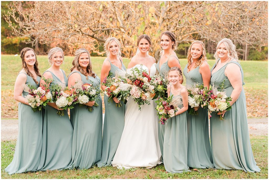 bride and bridesmaids smiling at camera in mint dresses at Waverly Estate