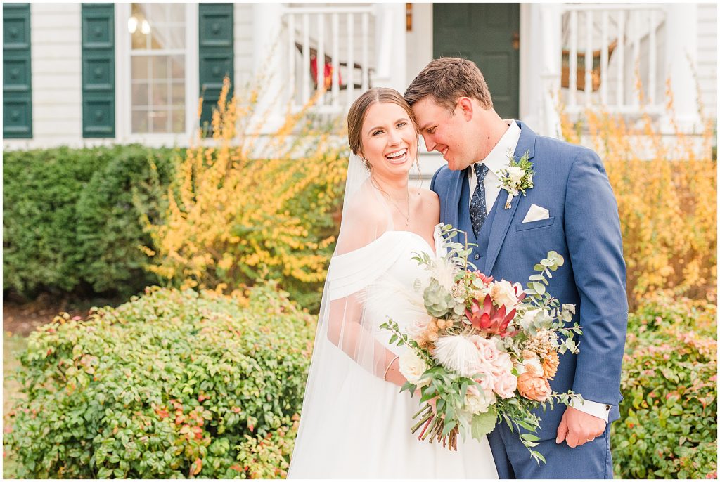 bride and groom laughing in front of plantation house at Waverly Estate in southern Virginia