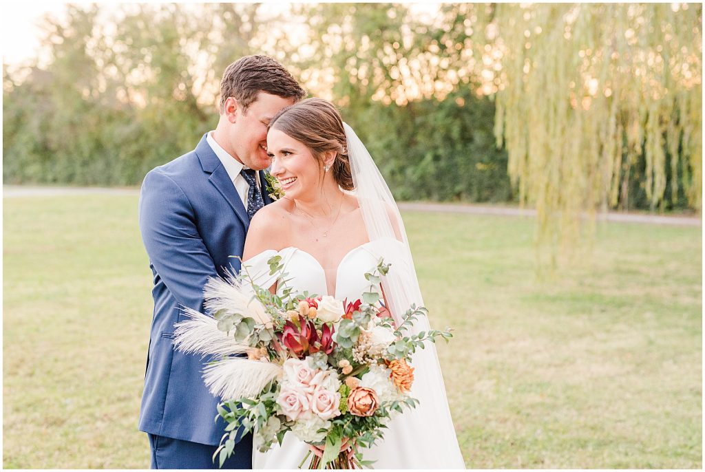 bride and groom walking in field at Waverly Estate in southern Virginia