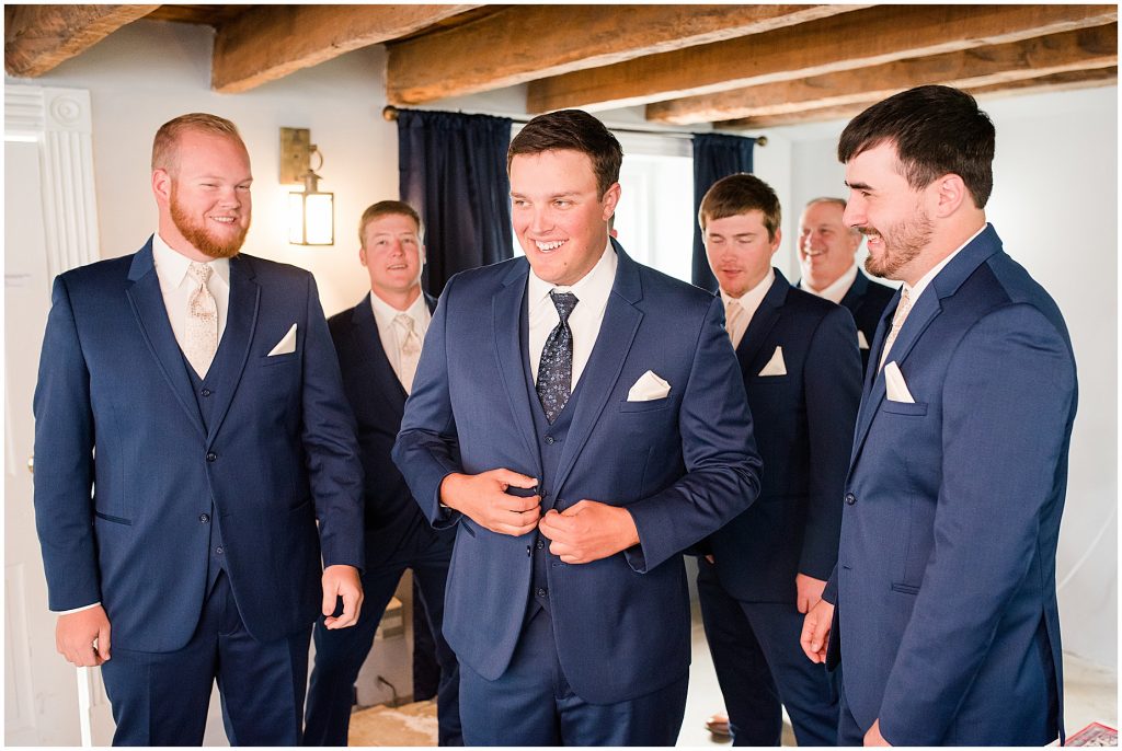 Groom and groomsmen getting ready in basement of waverly estate in southern virginia