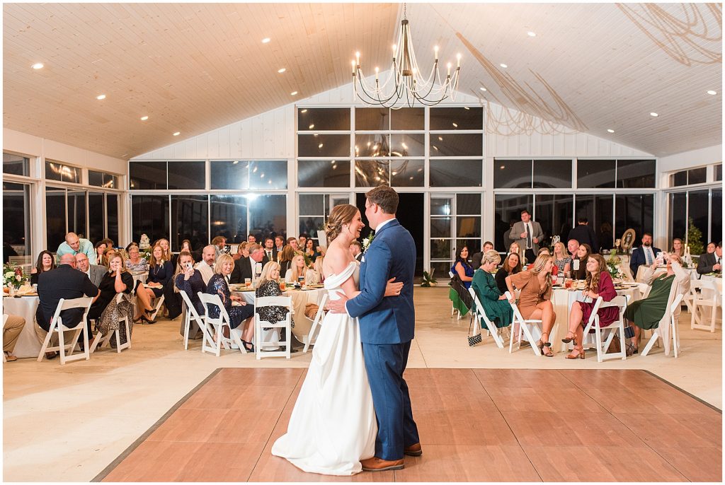 bride and groom first dance at Waverly Estate reception with guests behind them
