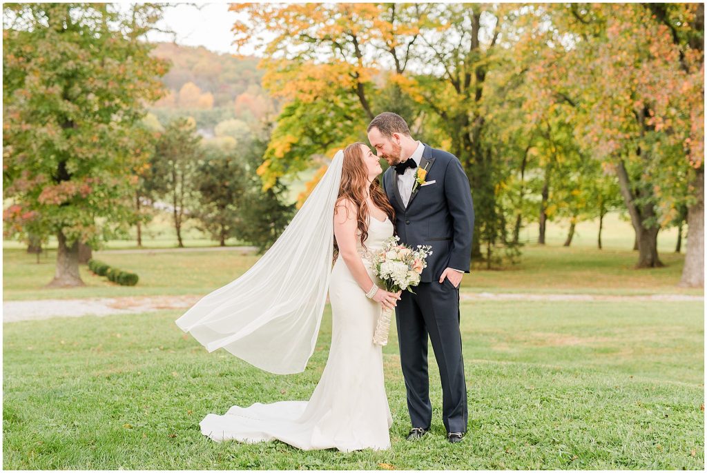 bride and groom portraits at whitehall estate in bluemont virginia veil blowing in wind