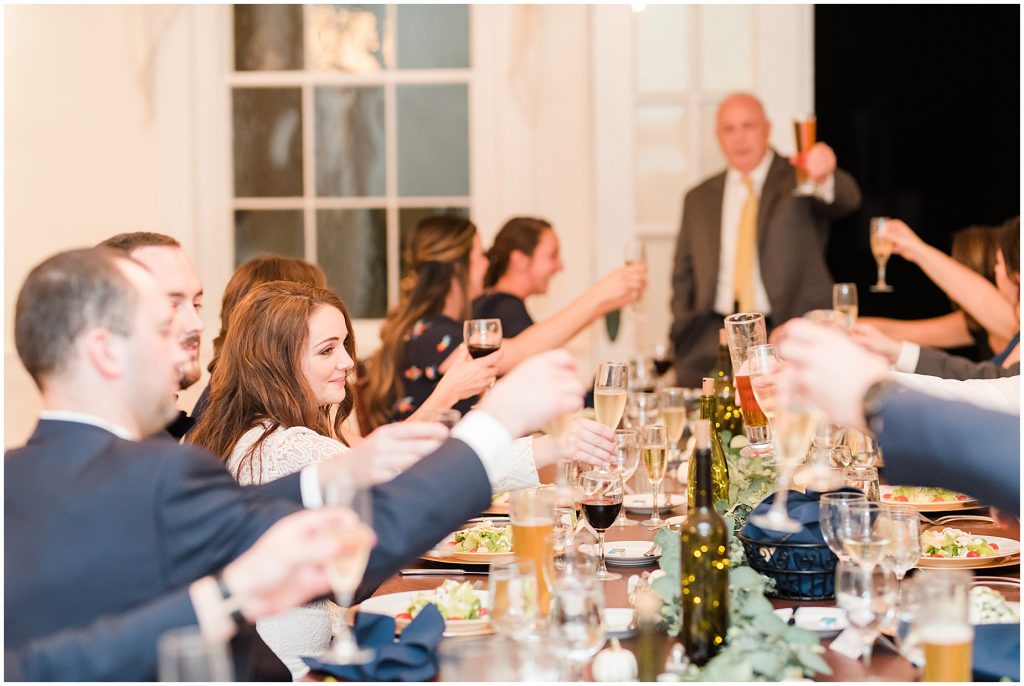 toasts for bride and groom at reception inside whitehall estate for mini wedding dinner
