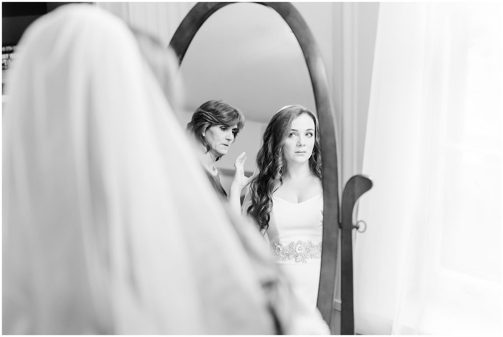 bridal suite at whitehall estate in bluemont virginia bride looking into the mirror in her dress
