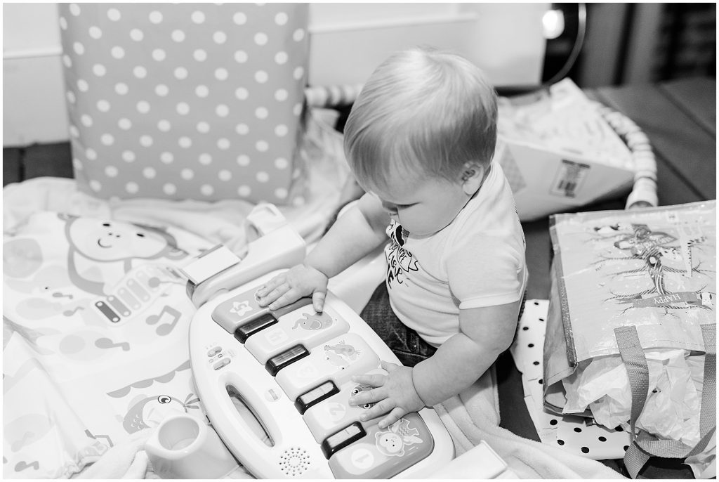 baby boy celebrates his first year birthday with pie and presents