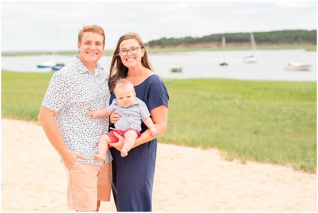 summer trip to cape cod with family standing on the beach near boats