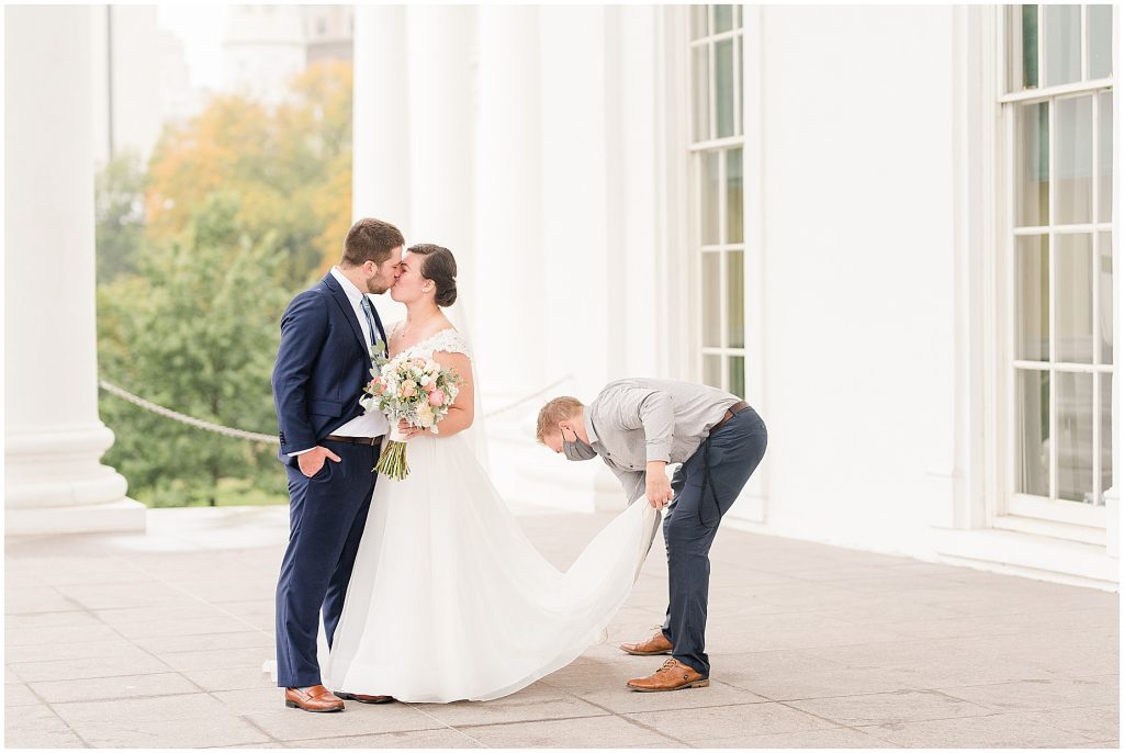 Virginia Photographers Behind the Scenes fluffing wedding dress with bride and groom at the virginia Capitol Building in richmond