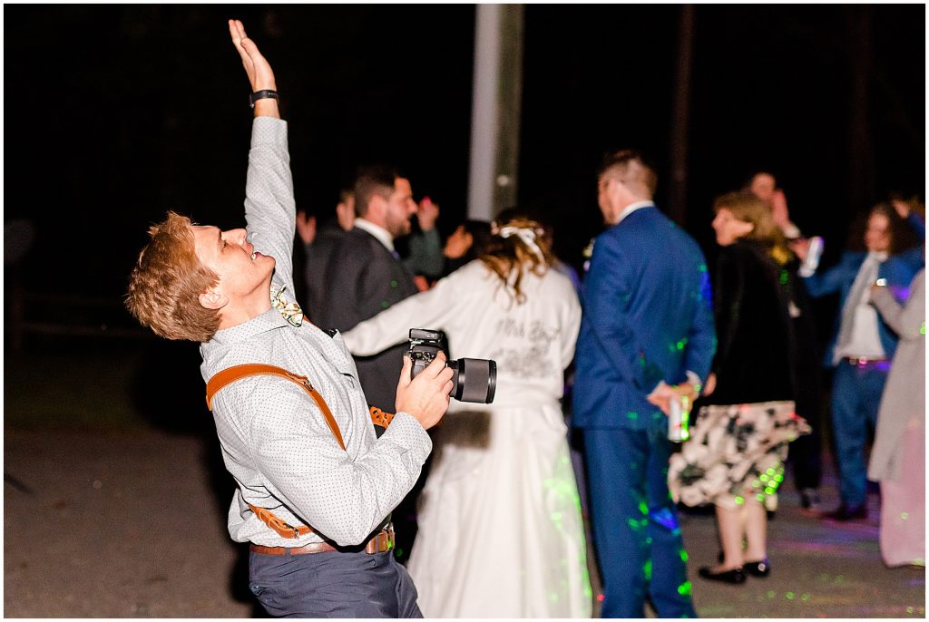 photographer dancing during reception