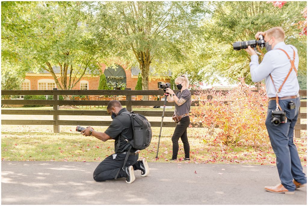 photographer and videographers taking photos of bride and groom