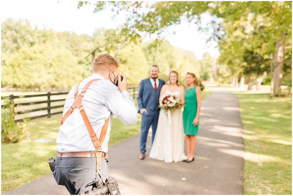 photographer taking family portraits at wisteria farms wedding in Richmond Va