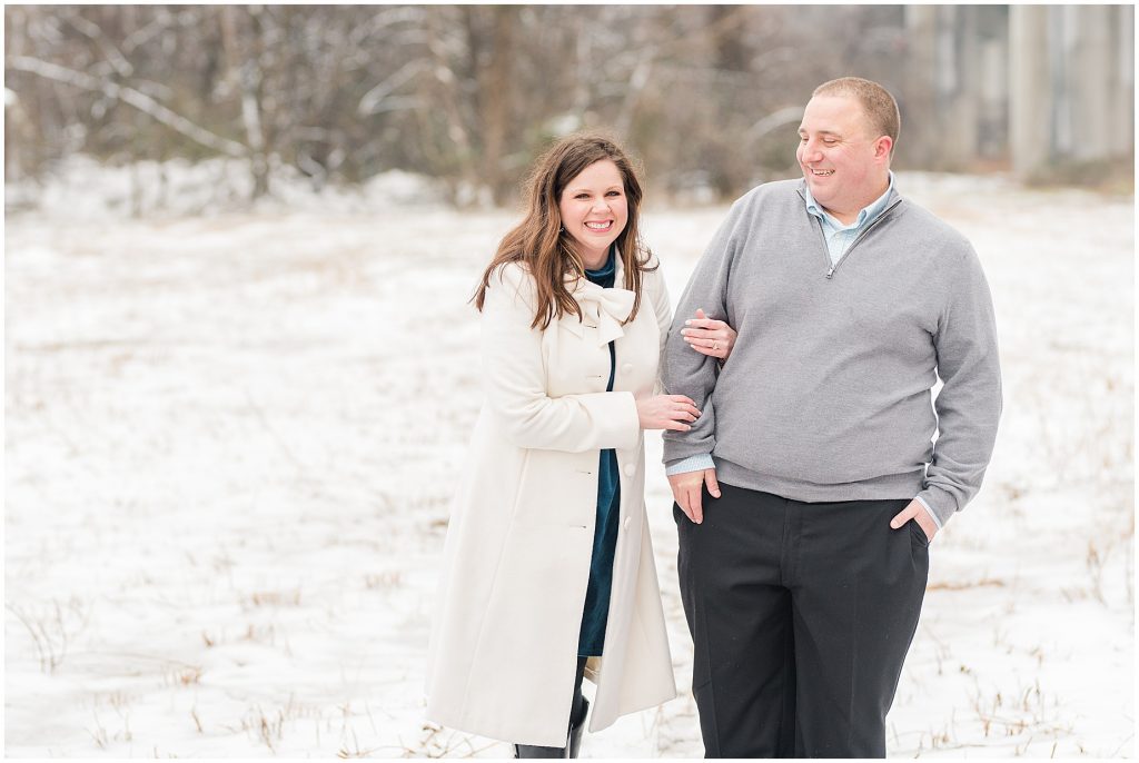 field on belle isle in richmond during the snow with engagement session couple