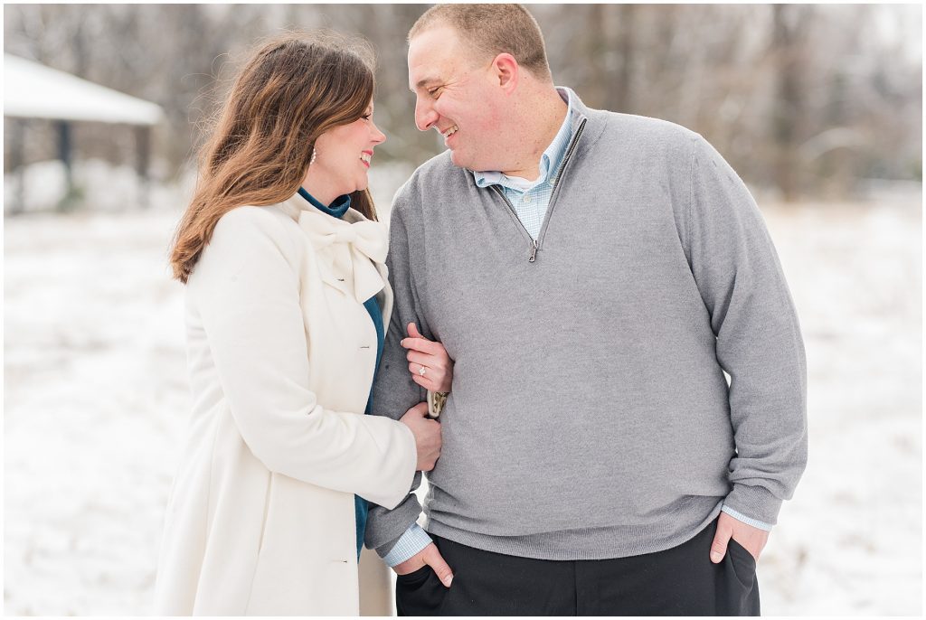 field on belle isle in richmond during the snow with engagement session couple