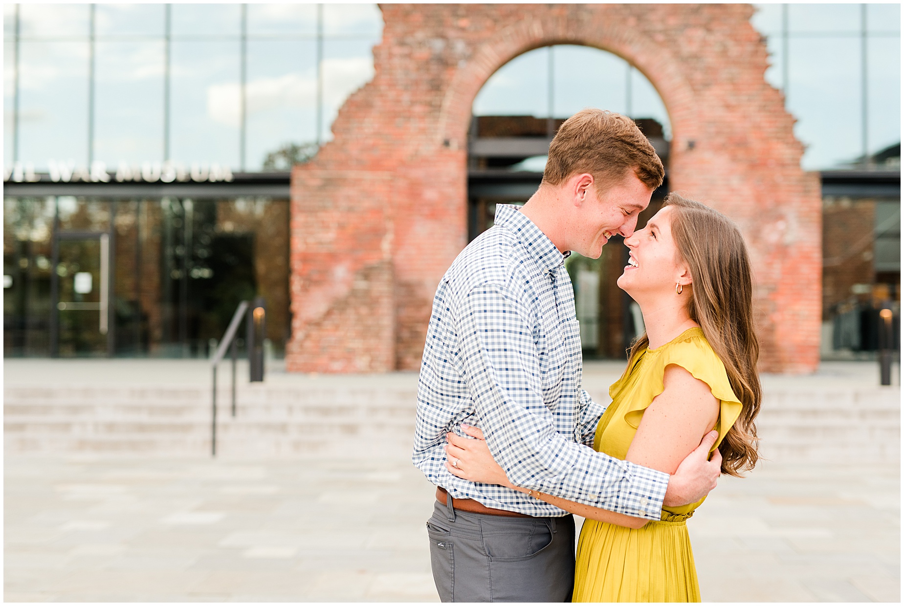 engagement couple in front of historic brick arch at tredegar museum in richmond virginia
