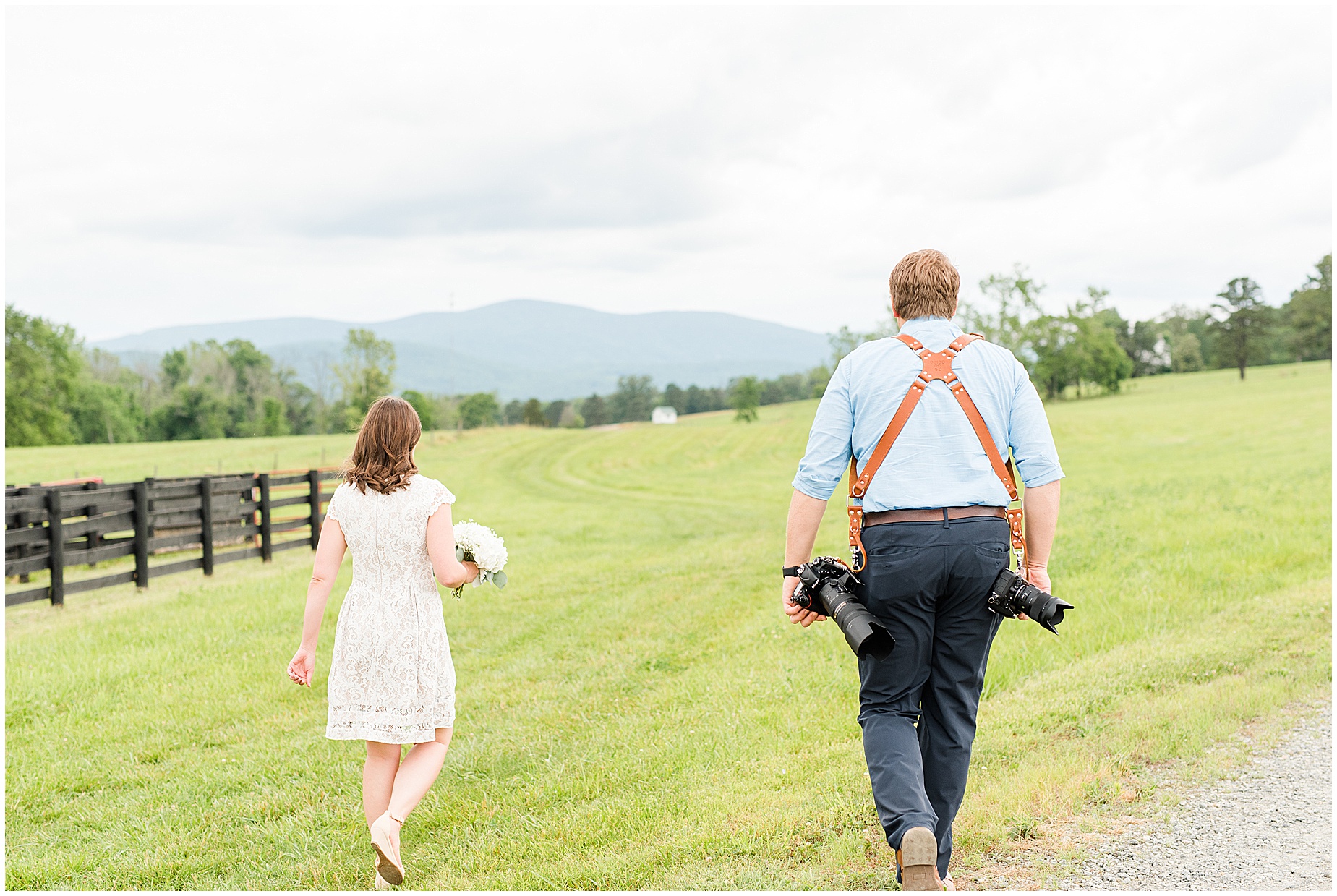 bride with photographer in a field at edgewood barn in Charlottesville