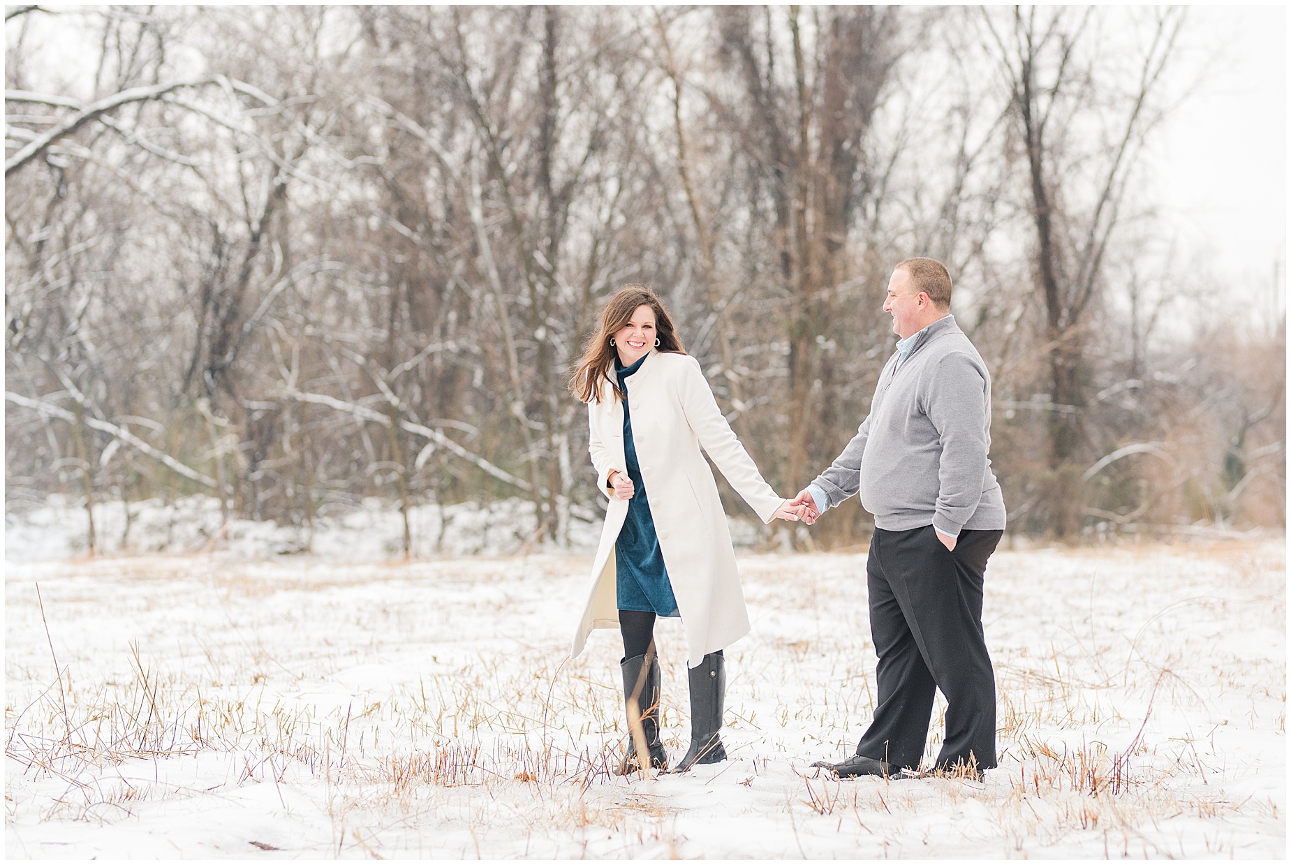 field on belle isle in richmond during the snow with engagement session couple